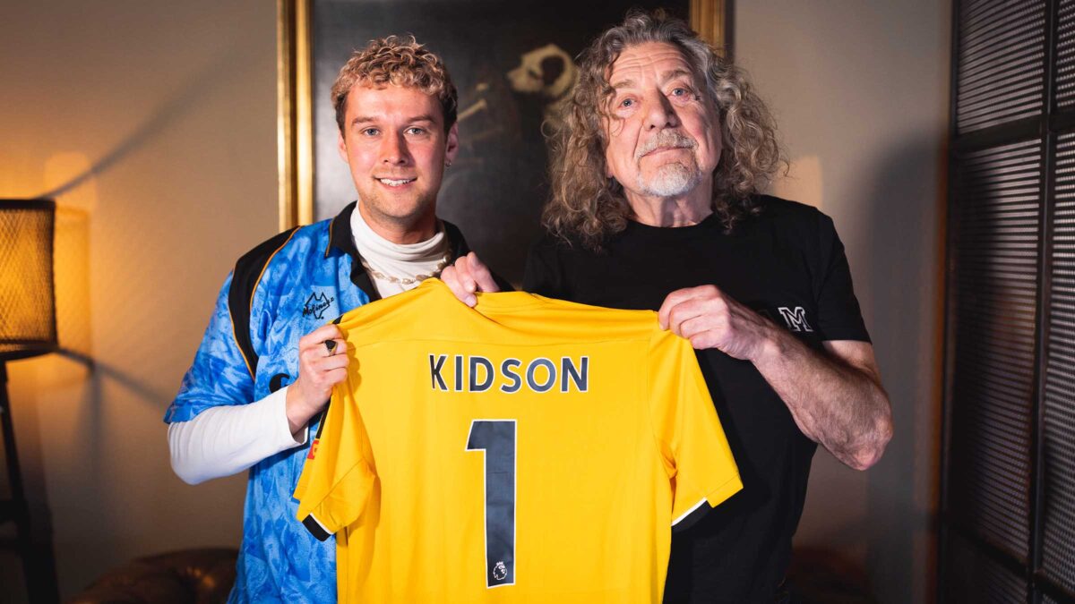 Ben Kidson holds a personalised Wolves jersey as he celebrates signing to Wolves Records with Robert Plant